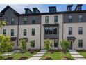 Beautiful townhomes with light brick and dark accents in a well-maintained community at 612 Marimba Pike, Mcdonough, GA 30253