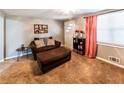 Cozy living area featuring comfortable furniture, a decorative shelf, and neutral decor at 6348 Garnet Dr, Douglasville, GA 30135