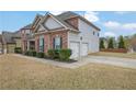 Two-story home featuring brick and siding, attached two-car garage, manicured landscaping, and inviting curb appeal at 4315 Balsam Bark Dr, Cumming, GA 30028