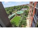 Condo view of community pool with lounge, mature trees, and residential buildings at 1820 Peachtree Nw St # 608, Atlanta, GA 30309