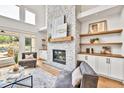 Inviting living room with stone fireplace, custom built-ins, and large windows at 2335 Flat Stone Dr, Cumming, GA 30041