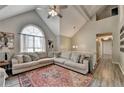 Comfortable living space with vaulted ceilings and a large window, creating a bright and airy atmosphere at 7040 Shady Oak Ln, Cumming, GA 30040