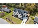 Beautiful aerial view of a white brick home with a dark roof, set on a well-maintained lawn with mature trees at 312 Meadow Dr, Alpharetta, GA 30009