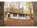 Charming single-story home with a white brick exterior and mature trees in a peaceful setting at 4336 Parkview Dr, Lithia Springs, GA 30122