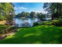 Lush green backyard with access to a lake featuring a private boat dock and plenty of space for recreation at 1187 Plantation Dr, Villa Rica, GA 30180