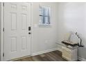 Bright foyer with a white front door, modern digital lock, and wood-look flooring at 1901 Creel Ln, Atlanta, GA 30349