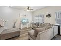 Comfortable living room featuring a gray sectional, ottoman, stylish decor, and wood-look floors at 1901 Creel Ln, Atlanta, GA 30349