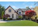 Beautiful brick home with a lush green lawn, manicured landscaping, and a welcoming entrance at 2461 Oak Grove Ne Ests, Atlanta, GA 30345