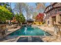 Resort-style pool with stone accents and lounge area, perfect for relaxation and entertaining at 2461 Oak Grove Ne Ests, Atlanta, GA 30345