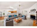 Spacious living room with vaulted ceilings, fireplace, and seamless flow into the adjacent kitchen at 57 Sorghum Ct, Dallas, GA 30157