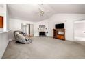 Spacious living room with vaulted ceilings, a fireplace and neutral carpet perfect for relaxation at 57 Sorghum Ct, Dallas, GA 30157