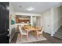 Cozy dining area with light wood floors and a view of the kitchen at 11352 Michelle Way, Hampton, GA 30228