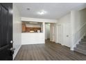 Open-concept living area featuring modern floors, leading to the kitchen and staircase at 11352 Michelle Way, Hampton, GA 30228
