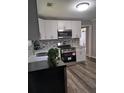This remodeled kitchen features white cabinets, stainless steel appliances and attractive tile backsplash at 1290 Elizabeth Ave, Atlanta, GA 30310