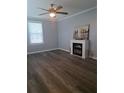 This living room has new floors, a ceiling fan, and a modern fireplace, providing cozy ambiance at 1290 Elizabeth Ave, Atlanta, GA 30310