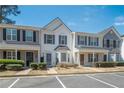 A view of the townhouse with blue shutters, with a landscaped lawn in the foreground at 1851 Devon Dr, Atlanta, GA 30311