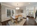 Bright dining room with large windows, decorative chandelier, and view into the living area at 2091 Mclendon Ne Ave, Atlanta, GA 30307