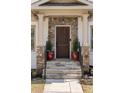 Inviting front entrance with stone accents, classic columns, and a beautifully crafted wooden door at 2091 Mclendon Ne Ave, Atlanta, GA 30307