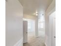 Bright hallway leading to rooms with carpet flooring and windows at 40 Kingfisher Walk, Covington, GA 30014
