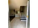 Inviting foyer with tiled flooring, a staircase, and views into the adjacent living areas at 4701 Flat Shoals Rd, Union City, GA 30291