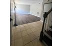 Open-concept layout with tile foyer leading to a living room featuring sleek dark wood flooring and gray walls at 4701 Flat Shoals Rd, Union City, GA 30291