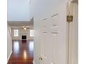 Inviting hallway with hardwood floors leading to a bright living room with a fireplace at 3515 Devon Chase Rd, Atlanta, GA 30349