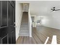 Inviting entryway featuring a staircase, wood flooring, and an open view to the living area at 4917 Walden Lake Sq, Decatur, GA 30035