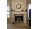Stone fireplace adorned with mantlepiece and decorative letter 'D' creating a cozy focal point at 68 Georgias Ln, Dallas, GA 30157