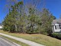 Landscaped front yard showing mature trees adjacent to single Gathering home in residential area at 68 Georgias Ln, Dallas, GA 30157