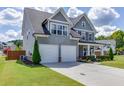 Stylish two-story home with a well-maintained lawn, tidy landscaping, and attached two-car garage at 1788 Hanover West Ct, Lawrenceville, GA 30043
