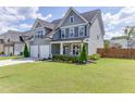 Beautiful home with a green lawn, gray siding, manicured shrubs, and a two-car garage at 1788 Hanover West Ct, Lawrenceville, GA 30043