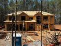 Exterior view of new home construction featuring exposed wood framing and sheathing at 3240 Miller Bottom Rd, Conyers, GA 30012