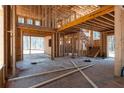 Interior view of new home construction featuring exposed framing and staircase at 3240 Miller Bottom Rd, Conyers, GA 30012