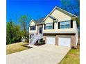 Inviting two-story home with a spacious driveway, showcasing a blend of siding and brick architecture at 4962 Newpark Nw Ln, Acworth, GA 30101