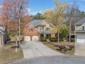 Aerial view of a brick and tan home, showcasing the surrounding neighborhood and landscaping, including a long driveway at 548 Lawton Bridge Sw Rd, Smyrna, GA 30082