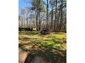 Expansive backyard with plenty of green space and mature trees, perfect for outdoor activities at 5687 Pine Meadow Ct, Morrow, GA 30260