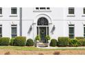 Close-up of the home's front entrance, featuring a decorative door and manicured landscaping at 2376 Massey Ln, Decatur, GA 30033