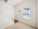 Bright entryway with staircase, plush carpet, and large window that allows natural light at 258 Venture Path, Hiram, GA 30141