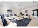 Spacious living room with plush seating, neutral colors, and ceiling fan at 258 Venture Path, Hiram, GA 30141