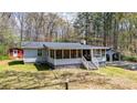 Sweet cottage featuring a screened-in porch and a separate shed, offering a relaxed, country feel at 528 Lower Scott Mill Rd, Canton, GA 30114
