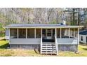 Inviting screened porch perfect for relaxation and enjoying outdoor views. Has stairs for easy access at 528 Lower Scott Mill Rd, Canton, GA 30114