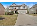 Beautiful two-story home with lush front lawn and two-car garage at 822 Pine Way, Dallas, GA 30157