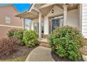 Inviting front porch with brick steps, landscaping, and elegant columns at 822 Pine Way, Dallas, GA 30157