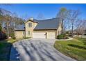 Spacious three-car garage with a long driveway at 2667 White Rock Dr, Buford, GA 30519