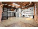 Bright open living area with exposed brick, loft, and modern kitchen details under a wood ceiling at 644 Wells Sw St # 8, Atlanta, GA 30310