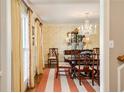 Formal dining room boasting a chandelier, wallpaper, shuttered windows and a striped rug at 2850 Gant Quarters Dr, Marietta, GA 30068