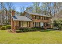 Beautifully landscaped brick home featuring a symmetrical design and a well-maintained lawn at 2850 Gant Quarters Dr, Marietta, GA 30068