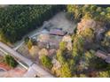 Stunning aerial view of a secluded home nestled among trees, offering privacy and natural beauty at 3856 Egypt Rd, Snellville, GA 30039