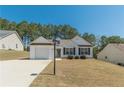 Inviting single-story home with an attached garage, manicured bushes, and a neatly kept lawn at 539 Creekview Overlook, Stockbridge, GA 30281