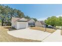 Delightful home with a one-car garage and a driveway on a sunny day in a quiet neighborhood at 539 Creekview Overlook, Stockbridge, GA 30281